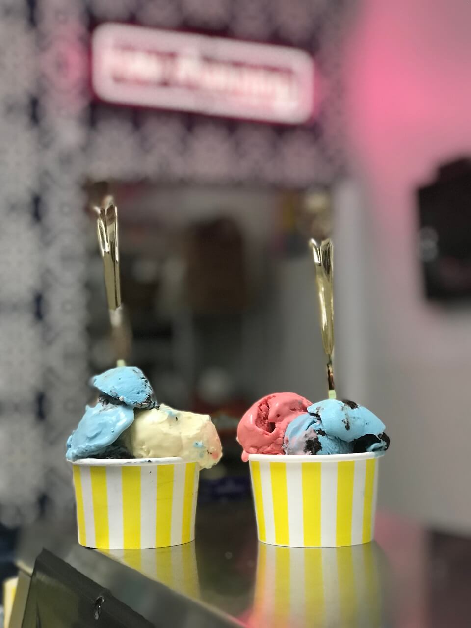 Two cups of scooped ice cream sitting on a counter